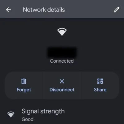 Android phone displaying the connected Wi-Fi network with a gear icon for advanced settings.