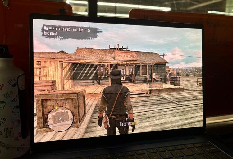 Moto Book 60 running a game at medium settings with smooth framerates.